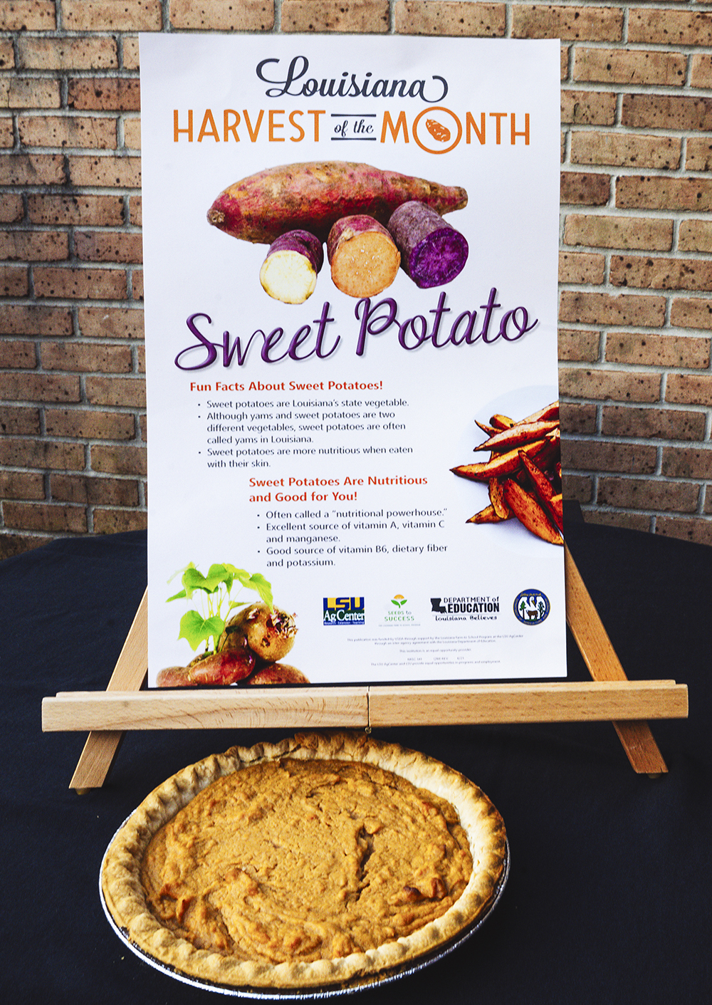 Pie in front of a poster identifying the Sweet Potato as the featured food in the Harvest of the Month program