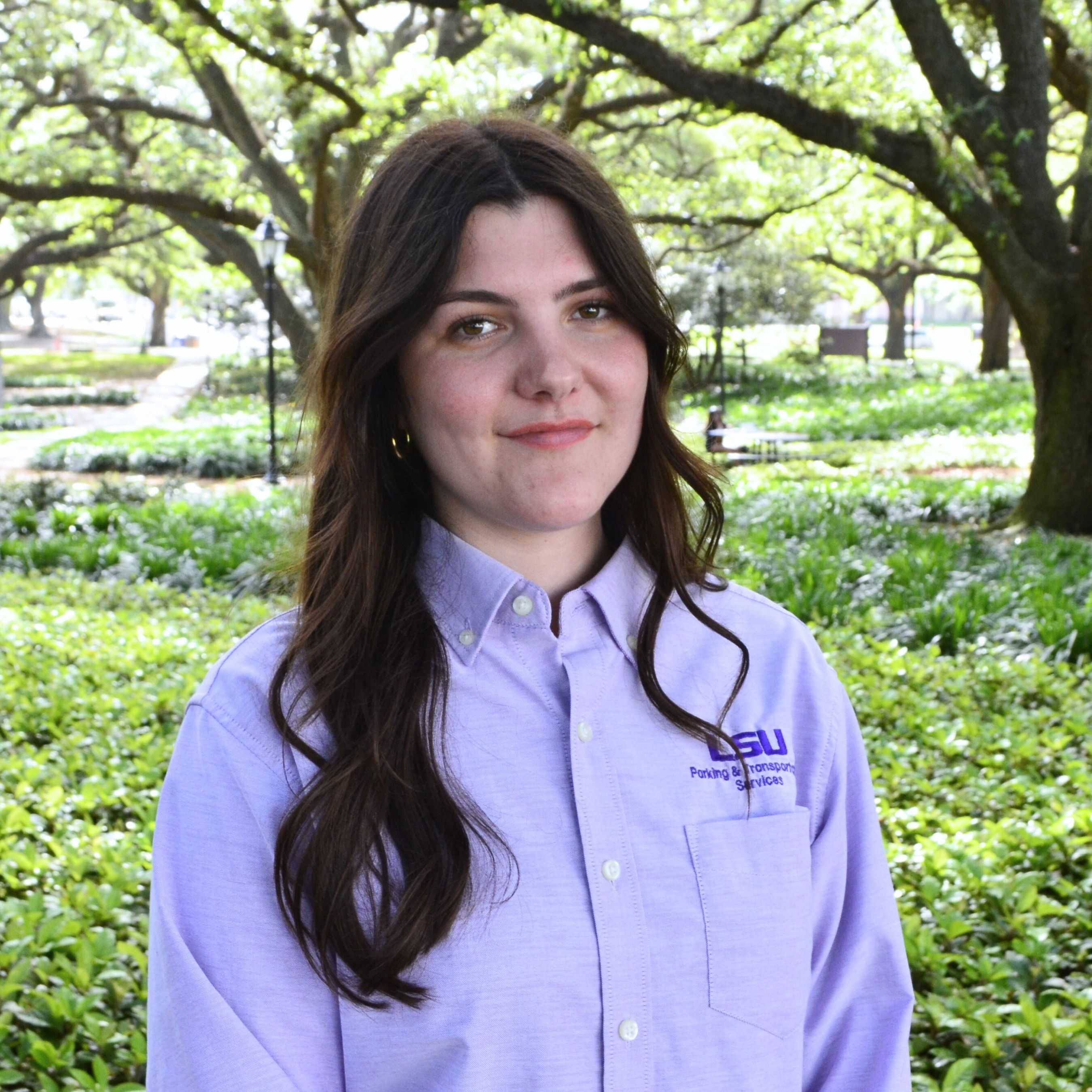 Smiling women in PTS purple polo