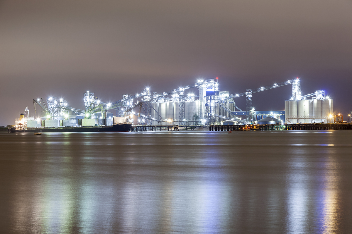 nighttime view of refineries from river